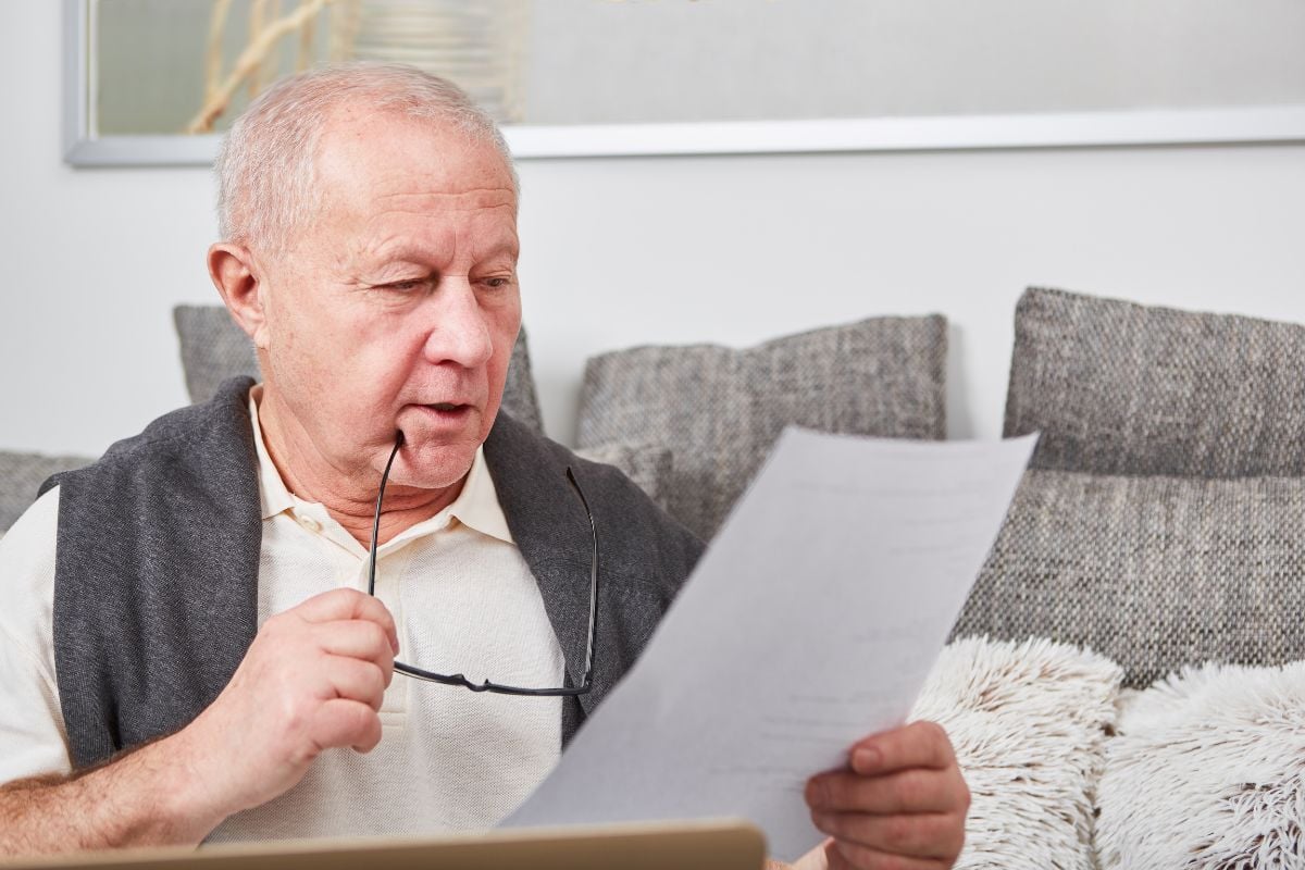 senior going over long term care insurance policy paperwork