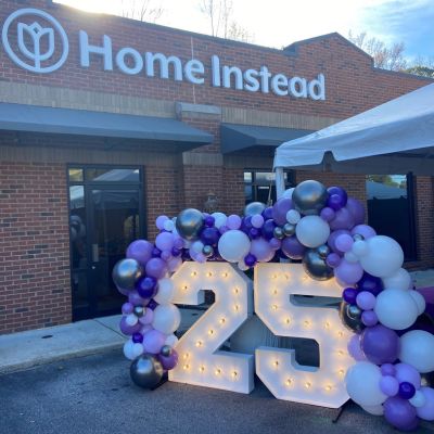 front of home instead office in birmingham alabama with celebratory 25th anniversary balloons out front