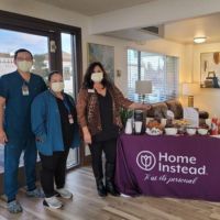 home instead team members at booth at roseville care center