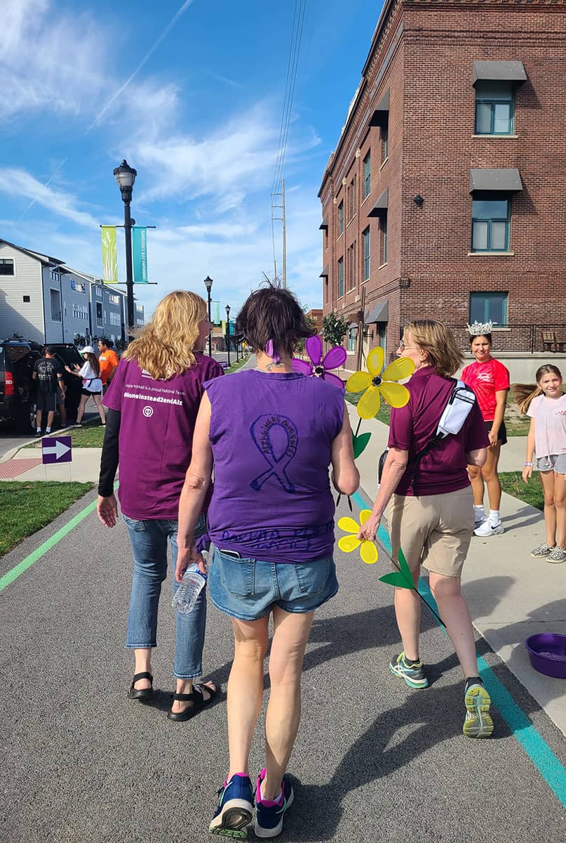 Photo of 3 care professionals walking away from the camera during the Walk to End Alzheimer's