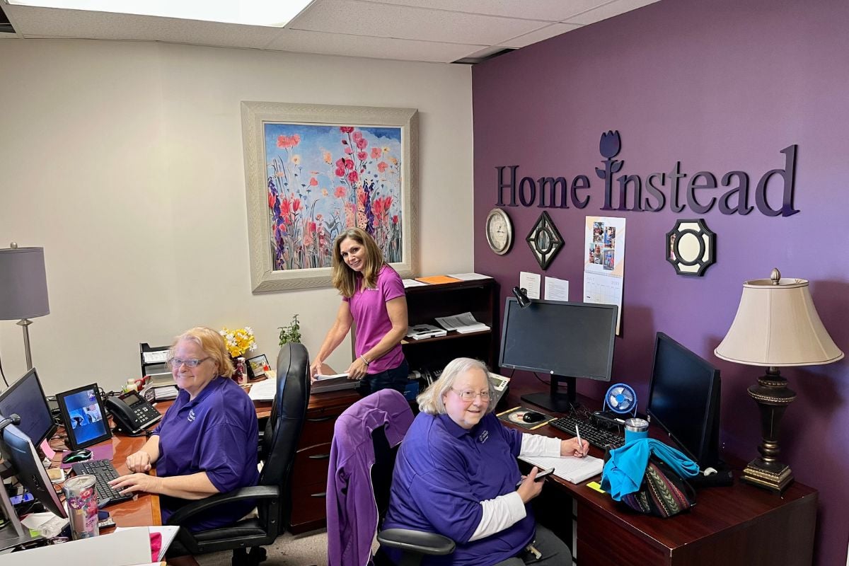 Home Instead team members at the front desk