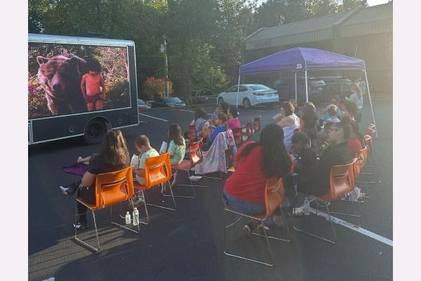 photo of home instead caregivers watching movie on appreciation night at spartanburg, sc