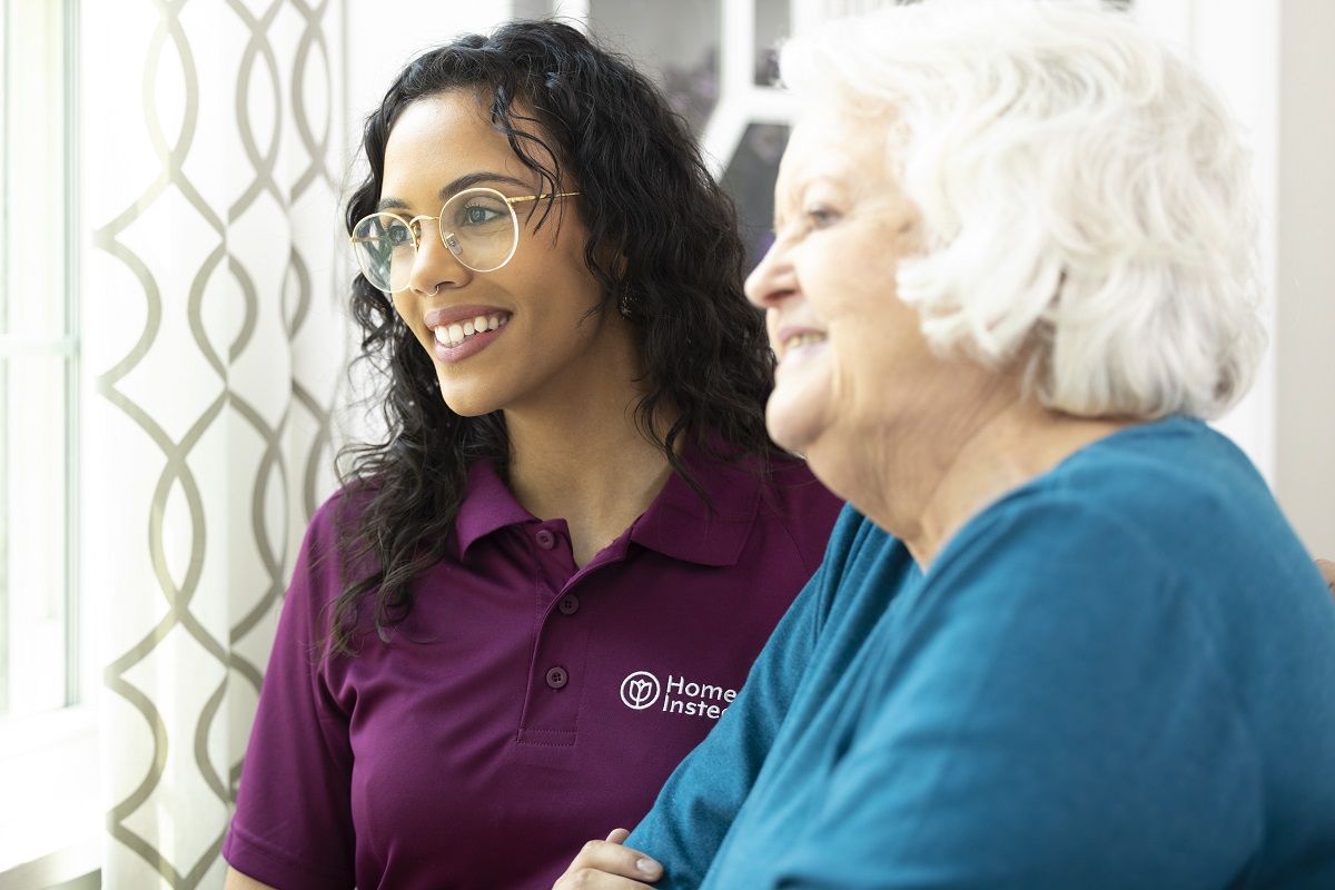 Home Instead and Honor Care Professional and aging woman smiling