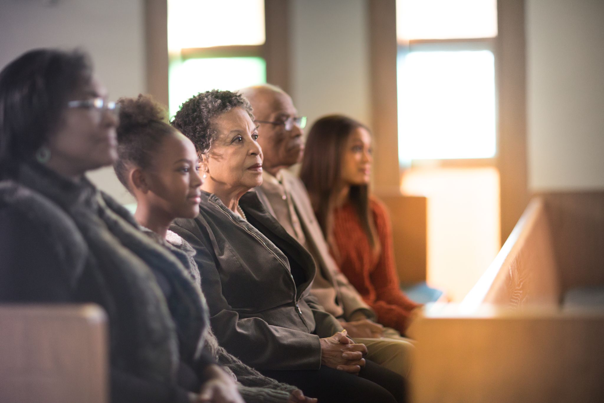 family sits together in church pew