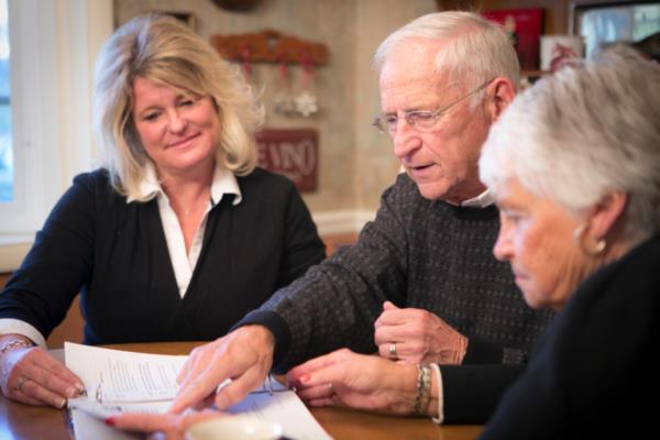 Senior man and woman review senior care options with daughter.