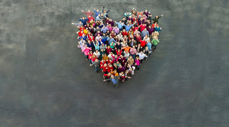 Home Instead Team Standing In Heart Shape top