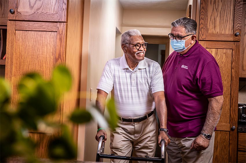  senior caregiver helping man with Alzheimer's care