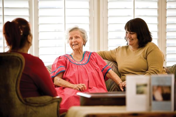 Adult children talking with aging mother